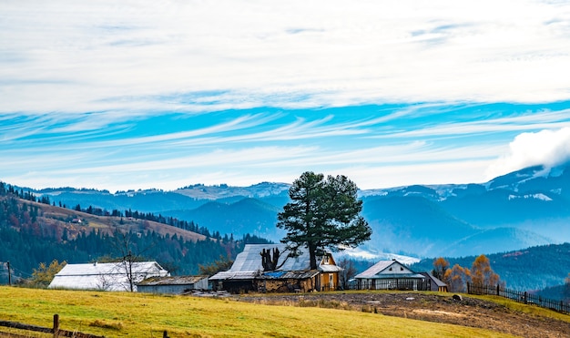 Beautiful colorful forests covering the Carpathian mountains and a small village against