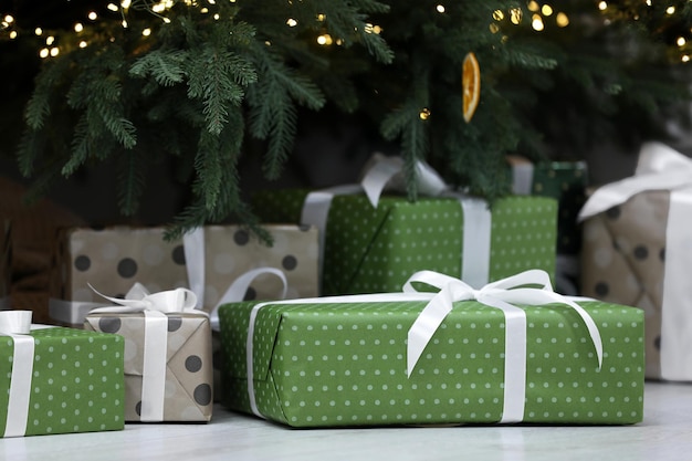 Beautiful colorful gifts under christmas tree indoors