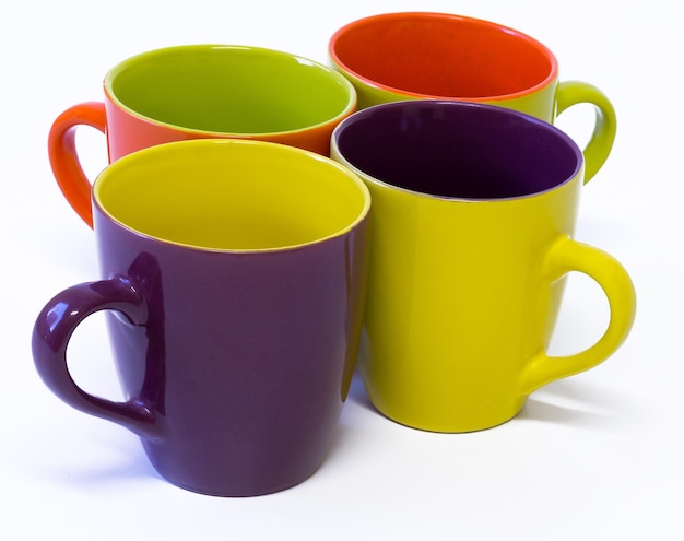 Beautiful colorful porcelain mugs in white background