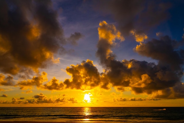 Beautiful colorful sunset or sunrise sky over sea with dramatic clouds nature environment background