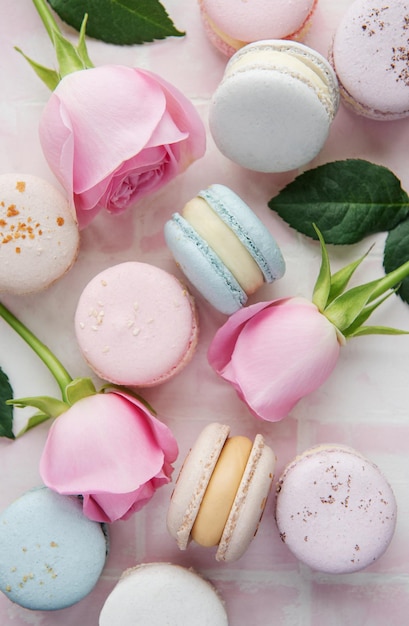 Beautiful colorful tasty macaroons on a pink tile background