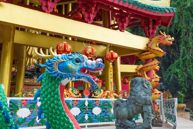 Beautiful colourful statues of dragons and lion at buddhist pagoda near Tiger Cave Temple in Krabi, Thailand