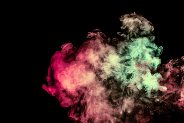 Beautiful column of smoke in the neon bright light of red green pink and turquoise on a black background exhaled out of the vape Nice pattern for printing and backdrop of colored waves