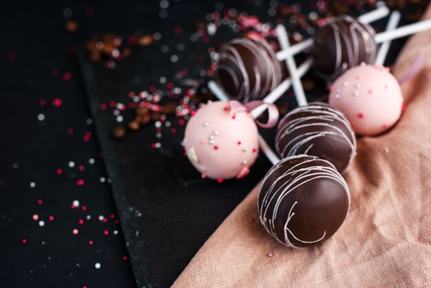 A beautiful composition of dessert on a stick with different cream.