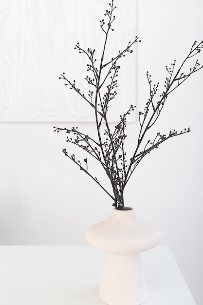 A beautiful composition of dried flowers in a stylish white vase In a bouquet of flowers photographed on a white background