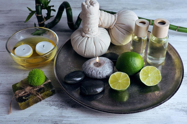 Beautiful composition of spa treatment on tray on light background