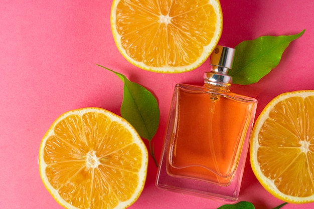 Beautiful composition with bottle of perfume and citrus fruits