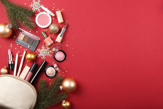 Beautiful composition with christmas decor and makeup cosmetics top view