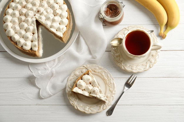 Beautiful composition with delicious banana cake on table