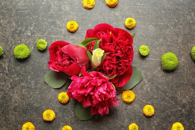 Beautiful composition with flowers and leaves on gray background