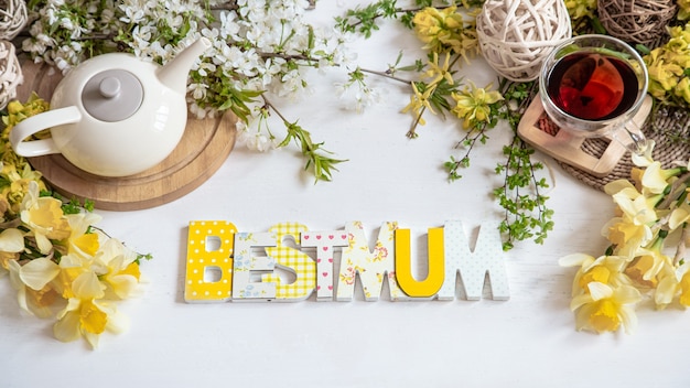 Beautiful composition with spring flowers for mother's day, and a wooden inscription best mother.