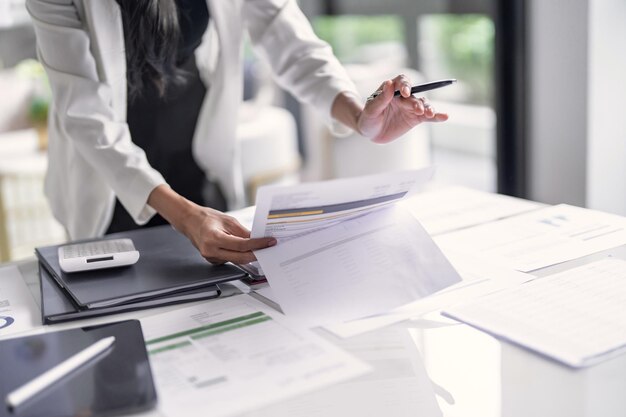 Photo beautiful confident asian business woman auditor or internal revenue service staff business women checking annual financial statements of company audit concept