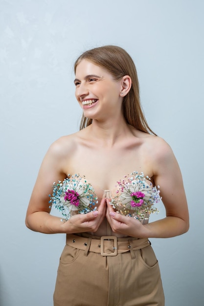 Beautiful confident woman holding fresh spring flowers in her hands Fresh flowers in the hands of a fairhaired woman