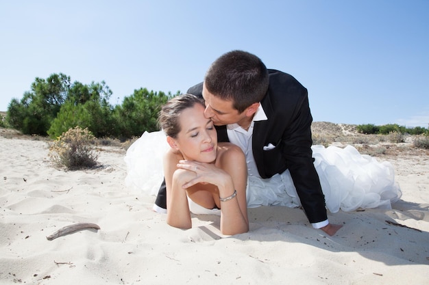 Beautiful couple on the beach in wedding dress