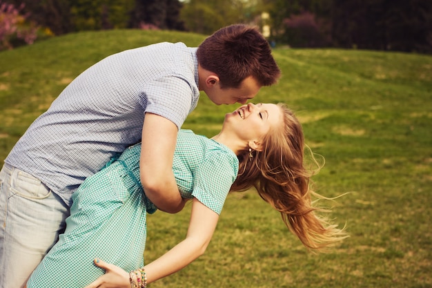 Beautiful couple on a date walking at the park. Copy space