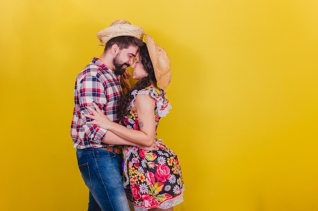Beautiful couple dressed in typical clothes for a Festa Junina Arraia de Sao Joao in a romantic pose dating