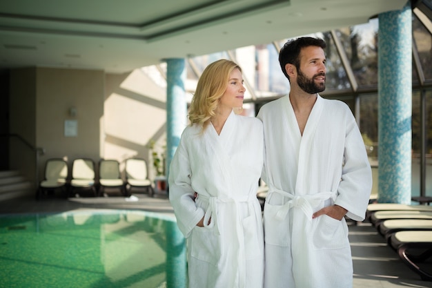 Beautiful couple enjoying spa wellness treatments