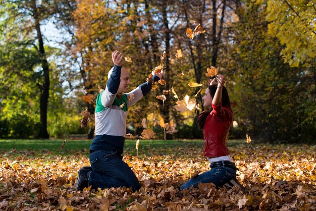 Beautiful Couple In The Heap Of Leaves