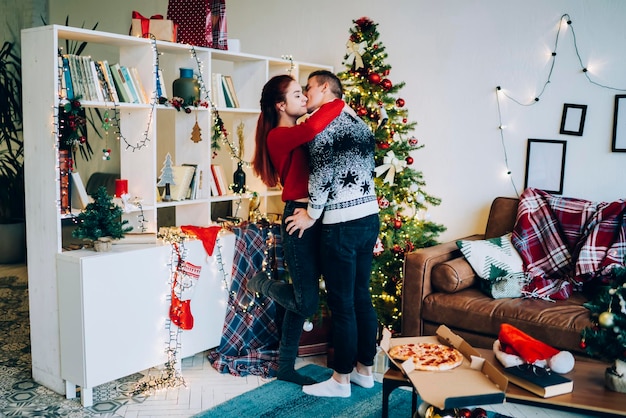 Beautiful couple hugging and kissing at apartment