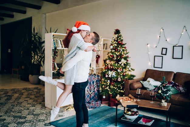 Beautiful couple hugging and kissing on Christmas