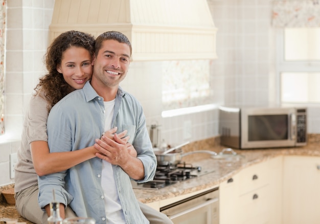 Beautiful couple hugging in the kitchen