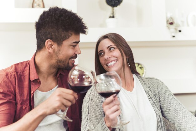 Beautiful couple is drinking winetalking and smiling