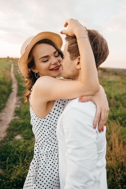 Beautiful couple kissing in nature on the of hills