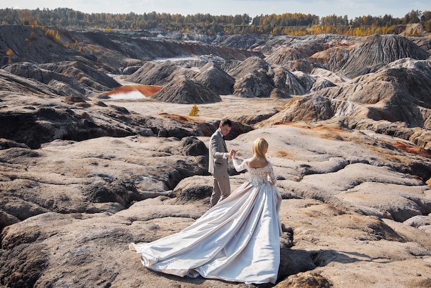 Beautiful couple in love on a fabulous landscape, wedding in nature, love kiss and hug. 14 September 2019