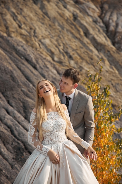 Beautiful couple in love on a fabulous landscape, wedding in nature, love kiss and hug.