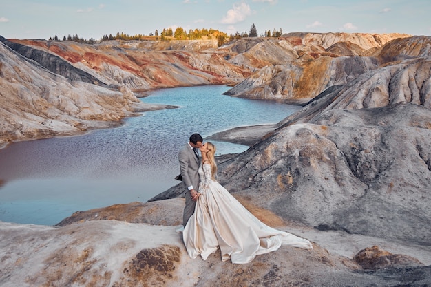 Beautiful couple in love on a fabulous landscape, wedding in nature, love kiss and hug