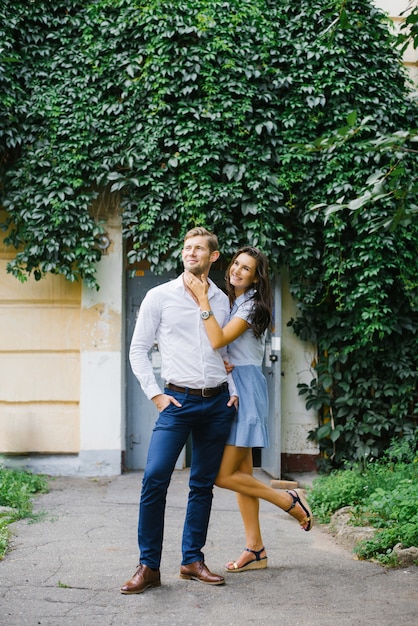 beautiful couple in love, a guy and a girl, have fun free time, walking through the city streets