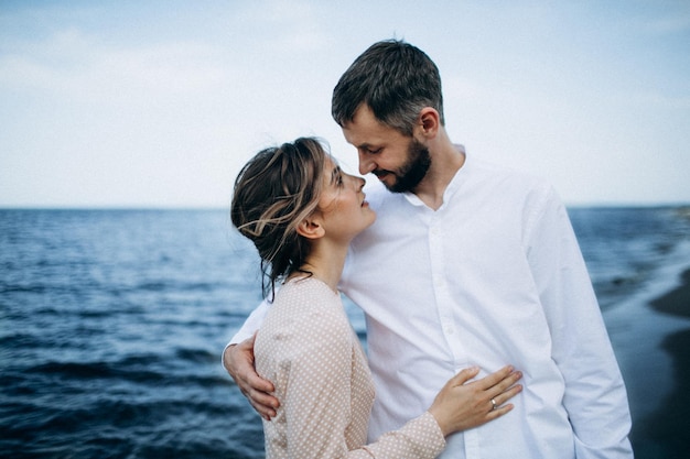 Beautiful couple in love on a lake beach