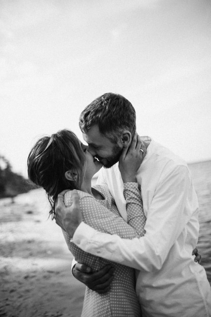 Beautiful couple in love on a lake beach