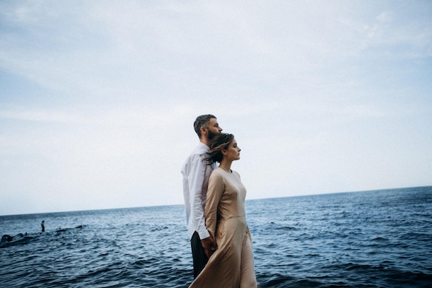 Beautiful couple in love on a lake beach