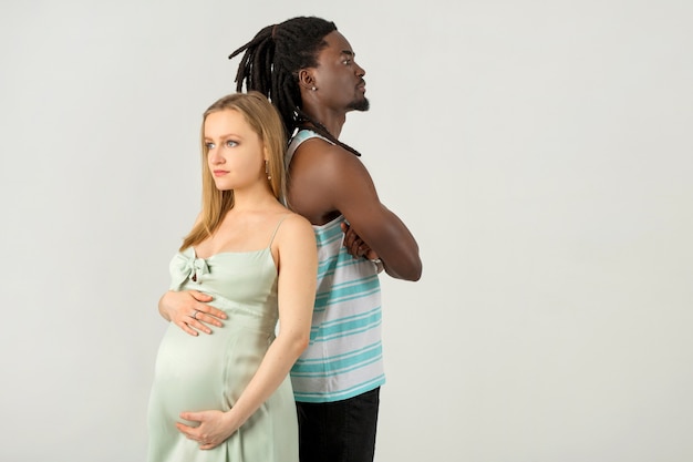 Beautiful couple of man and pregnant woman on a white background