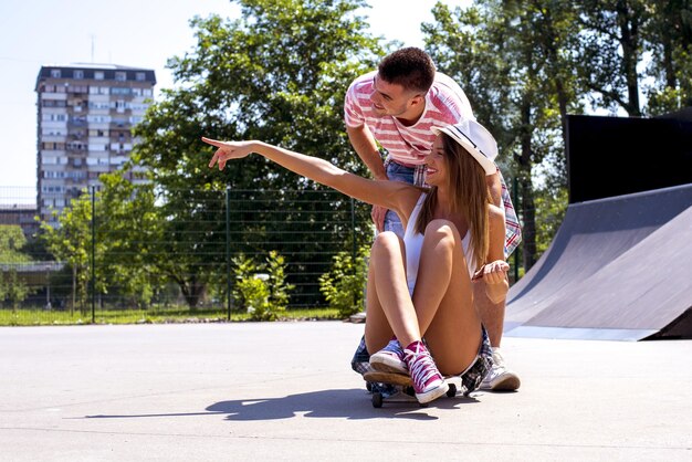 Beautiful couple in a skate park under the sunlight