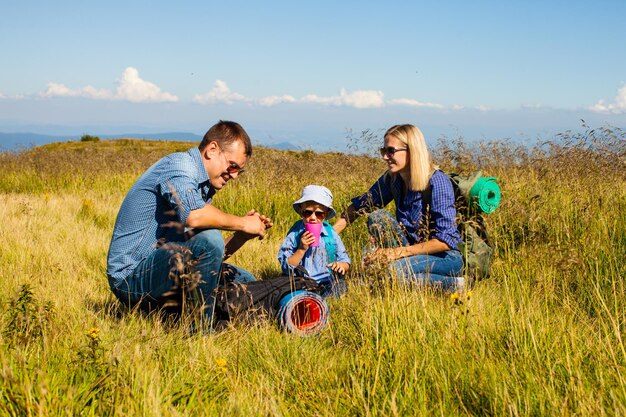 The beautiful couple with a son glad to relax while traveling