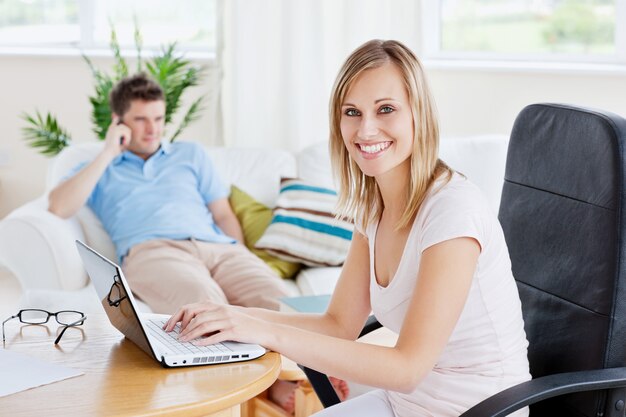 Beautiful couple. Woman using laptop 