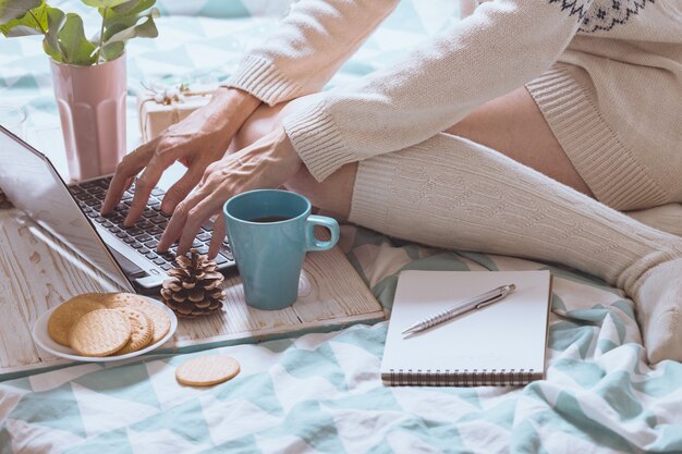 Beautiful cozy morning - girl sitting with a laptop