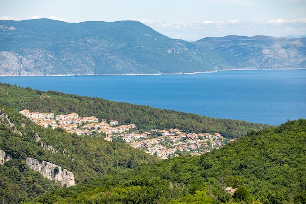 Beautiful croatian coast rising above the Adriatic sea with houses from the small town of Rabac