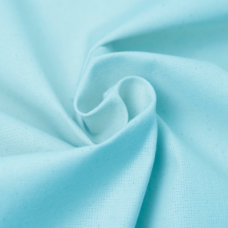 Photo beautiful crumpled textile texture of delicate blue color.