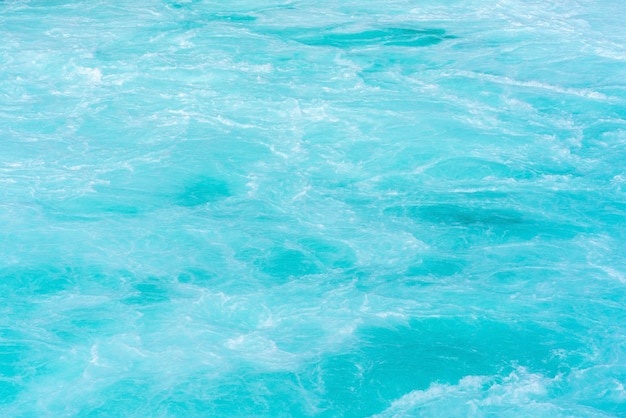 Beautiful crystal clear turquoise current of The Huka falls located in Wairakei Park of Taupo , North Island of New Zealand