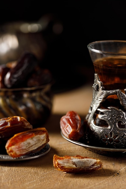 a beautiful cup of tea with dates and dried fruits on the table Closeup