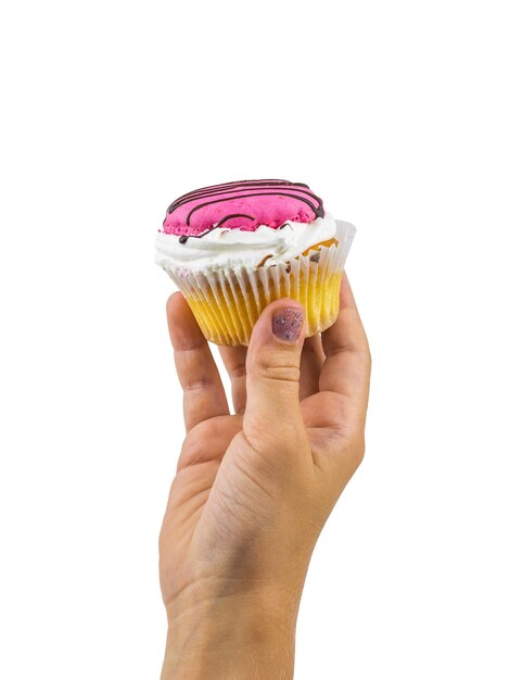 Photo beautiful cupcake in baby's hand isolated on white background. freshly prepared homemade sweetness in the hands of a child.