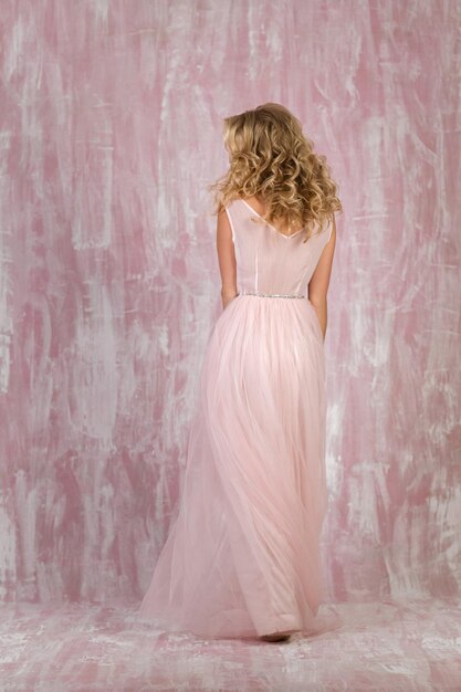 Beautiful curly blonde bride pink dress