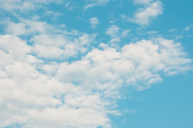 Beautiful curly clouds with turquoise sky background. Sunny weather cloudy sky