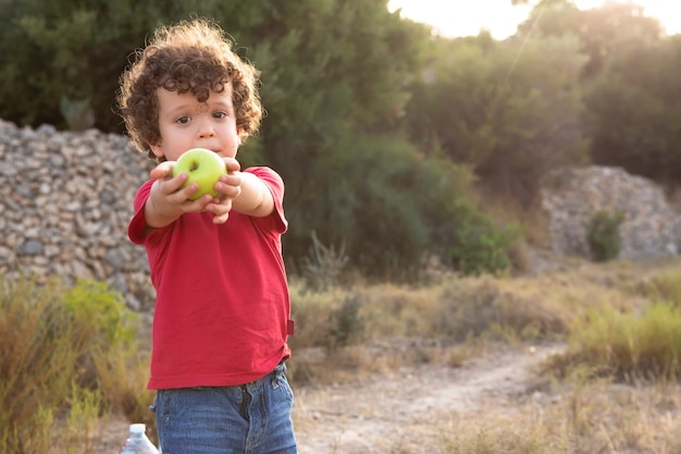 Beautiful curly haired boy in the field