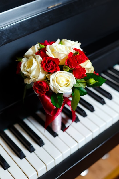 Beautiful and cute bridal bouquet lying on the piano