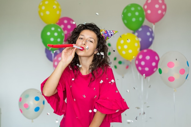 Beautiful cute cheerful girl with colored balloons. Holiday Happy Birthday.