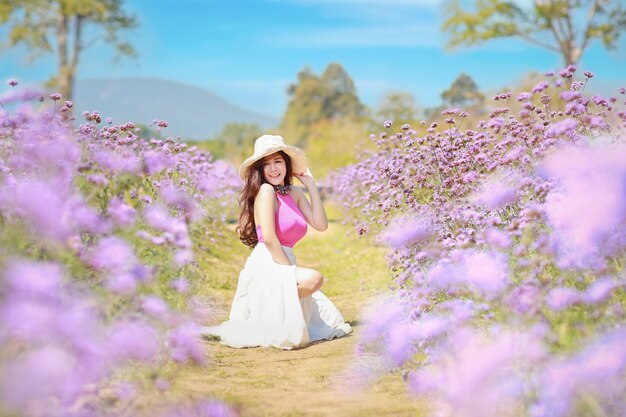 Beautiful cute girl portrait enjoying in flowers farm